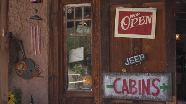 Open sign hanging on wooden door