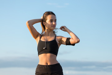 A young slim athletic girl in sportswear with snakeskin prints performs a set of exercises. Fitness...