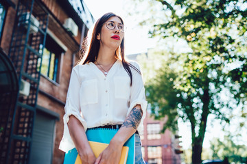 Sensual lady with notepad standing in street