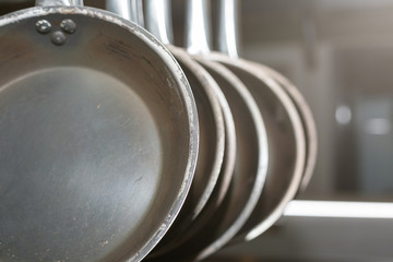 Cast iron frying pans hang in the kitchen.
