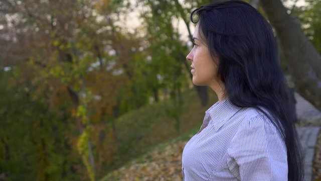Beautiful Girl Standing And Thinking In The City Park On The Hill. Looking On Evening (Morning) Sky Above Cityscape. Summer Autumn Season