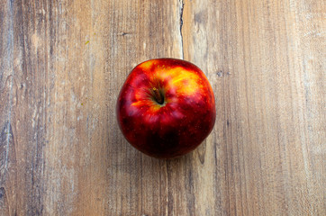 Photo of red an apple on the wooden background