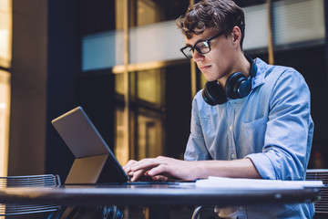 Young man using tablet with keyboard at workplace