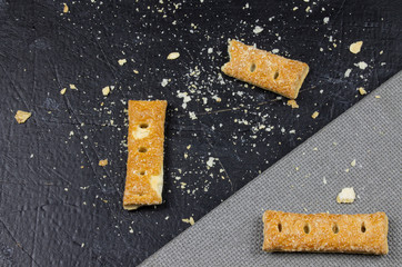 Top view crushed cookies photo on the black cardboard gray texture