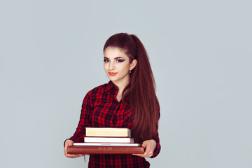 Portrait of a confident smiling young student woman holding books, folder and laptop, all she need for studies.