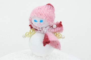 toy baby snowman in pink clothes