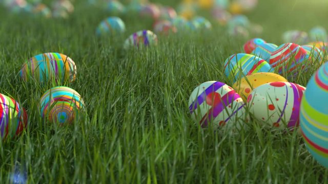 Easter eggs on the grass. Easter eggs slide down the slope covered with green cereal. Sunny positive climate. Beautiful surroundings and cheerful animation.
