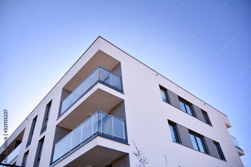 Wall mural Contemporary residential building exterior in the daylight. Modern and new apartment building. 