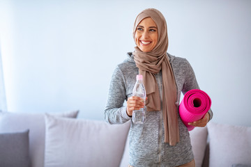 Islamic woman preparing for workout. Young muslim woman ready to running. Islamic woman resting and drinking water. Young muslim woman packing sports stuff for training...