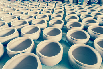 Filtered image group of raw unbaked clay terra cotta pots full background in Hanoi, Vietnam