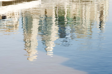 Unusual view of Puerto Madero. Modern buildings reflected in moving water