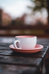 Beautiful pink teacup in on the table.