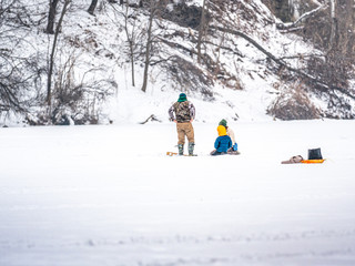 Young family enjoying ice fishing in Wisconsin