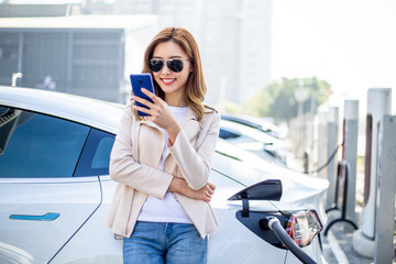Woman charging electric car