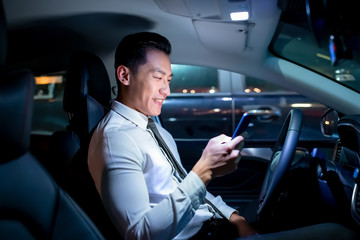 businessman use smartphone in car