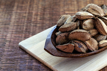 Brazil nut with shell, grown in Brazil and Bolivia. Chestnut exported worldwide.Space for text.