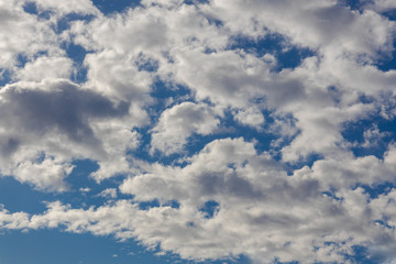 Naklejka na ściany i meble Beautiful cloud texture with vibrant blue sky background