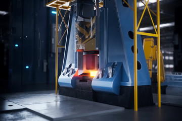 Hot metal billet under the press.