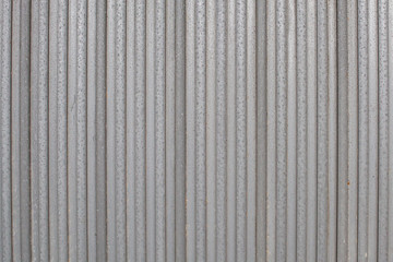 metal sheets next to each other form the foundation for a metal gate or fence. Structure for background or wallpaper