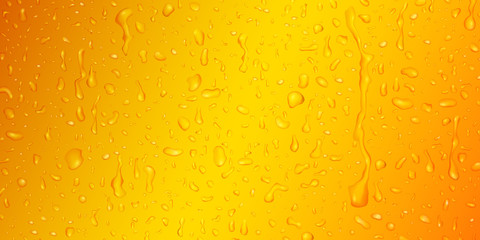 Background with drops and streaks of water in yellow colors, flowing down the surface