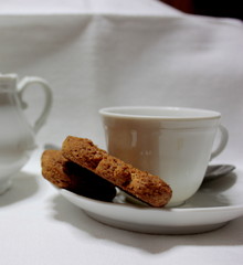 cup of coffee and cookies on wooden table
