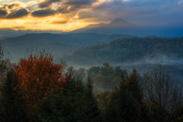 Dawn light breaks through storm clouds over the Smoky Mountains.
