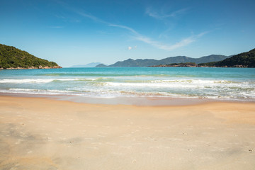 Fototapeta na wymiar Beautiful view of Parnaioca beach in Ilha Grande, a tropical beach visited on a boat trip on the south coast of Rio de Janeiro, on the coast of Brazil during a sunny day of holidays and sightseeing.