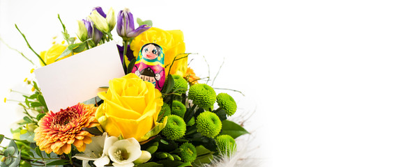 yellow bunch of flowers, greeting card with space for text and barbuschkas with child handwriting