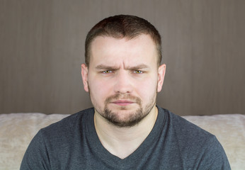 Close up portrait of a handsome young man looking at camera