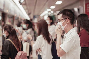 Middle aged Asian man wearing glasses and medical face mask,  coronavirus covid-19 delta virus post...