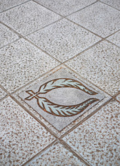Laurel wreath, symbol of triumph and glory, a decorative relief in  a pavement stone, perspective view.