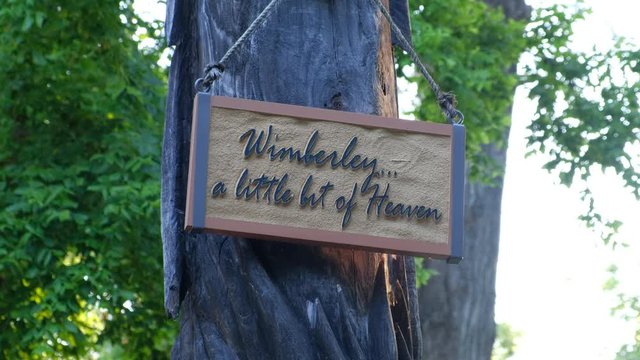 Wimberley, Texas -  Welcome sign with the text "A little bit of heaven" attached to tree. This is a famous central Texas Hill Country destination
