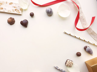 Valentines Day background. Rose, rose petals,chocolate,tube and ribbon beautiful. Isolated on pastel pink backgrounds. Valentines day concept. View from above. There is a middle area on pink floor.