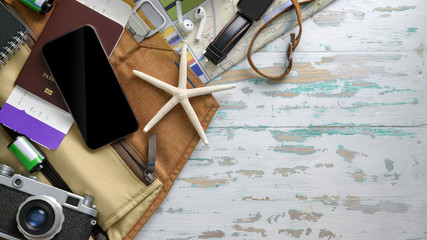 Overhead shot of Traveler's accessories with smartphone, camera, boarding pass and other travel items
