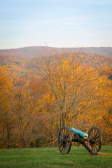 Fototapeta na wymiar Ancient Cannon from the Civil War at the Antietam National Battlefield in Sharpsburg, Maryland, USA with colorful Trees on a Autumn Day