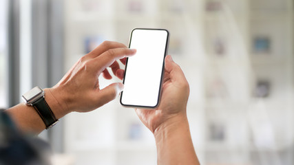 Close-up view of businessman using blank screen smartphone