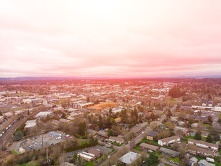Suburb in the United States, houses in a row and housing estate. Shot from a height at sunset or dawn.