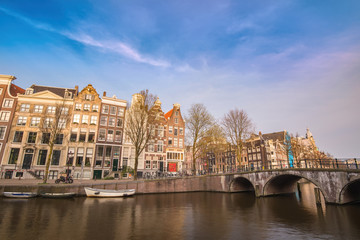 Fototapeta na wymiar Amsterdam Netherlands, city skyline at canal waterfront and bridge with traditional house