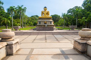 An iconic golden Buddha statue in Viharamahadevi Park a public park located in Colombo, Sri Lanka....
