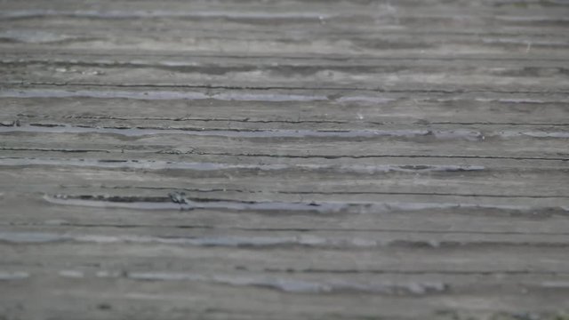 rain fell slowly on the surface of the cemented road