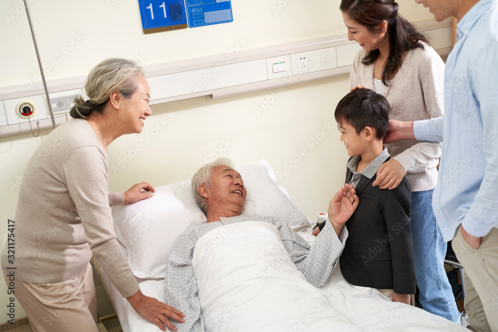 Wall mural asian family visiting grandpa in hospital