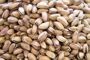 Pistachios are scattered on the table. Background for design