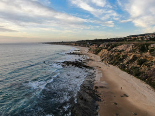 Aerial view of Newport Beach, cliff and beach during sunset twilight in southern California, USA