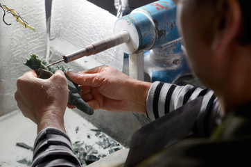 Craftsman carving jade stone with a water cooled diamond dremel in Beijing China © Reimar