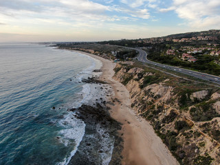 Aerial view of Newport Beach, cliff and beach during sunset twilight in southern California, USA