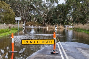 Road closed due to flooding showing road closed sign
