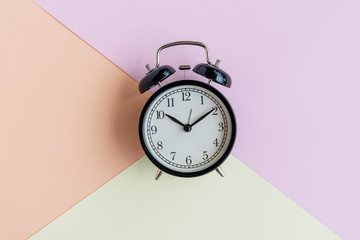 Alarm clock on pastel background - still life conceptual