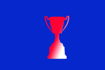 Blurry image of Trophy and medal design closeup on blue black background