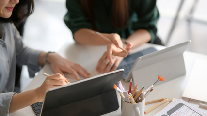 Cropped shot of application developer team drawing on their UI project in co working space