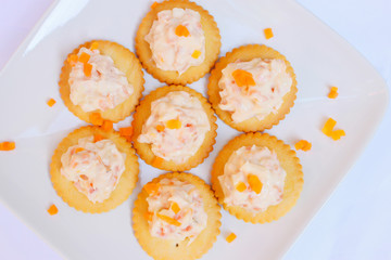 Tasty crackers with cream cheese,carrot.Healthy snacks, on dish